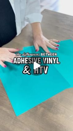 two hands on top of a piece of paper with the words adhesive vinyl and htv