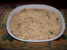 a white bowl filled with food on top of a table