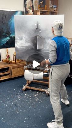 a man is painting in an art studio