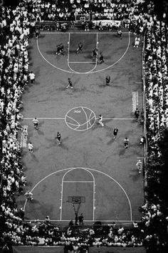 an aerial view of a basketball court with people playing