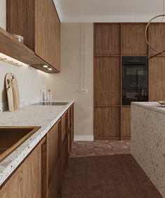 a kitchen with marble counter tops and wooden cabinets