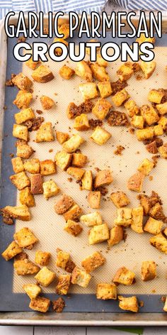 garlic parmesan croutons on a baking sheet with text overlay that reads garlic parmesan croutons