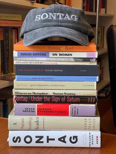 a stack of books sitting on top of a wooden table