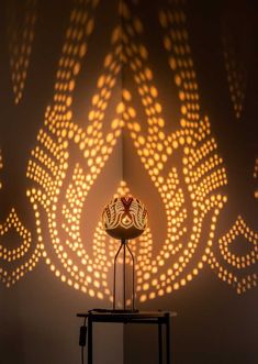 a lamp that is on top of a table in front of a wall with lights