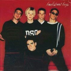 an album cover with four men in black sweaters and one man wearing sunglasses standing next to each other