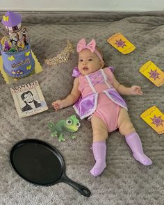 a baby is laying on the floor next to some toys