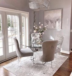 a dining room table with chairs and a chandelier