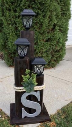 some lights that are sitting on top of a wooden block with the letter s in it