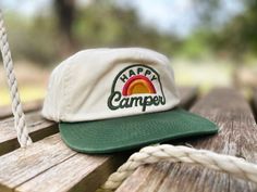 Fulfilled by our friends at RIVER ROAD CLOTHING CO. Bring that happy, peaceful calm you get from camping into your every day! Now your kid can be a "Happy Camper" no matter where they're at. Fit ages 3-8. - Washed cotton/twill lightweight fabric- Unstructured crown with flip up mesh behind front panel- Slightly pliable bill- Stash Pocket- Snapback closure- 5 Panel. Seamless Front - River Road label Moh Duties, At The Gas Station, Camping In The Woods, Doing Chores, River Road, Standing In Line, Vintage Trucker Hats, Hat Embroidery, Granola Girl