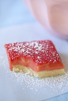 a piece of cake with powdered sugar on it sitting on top of a table