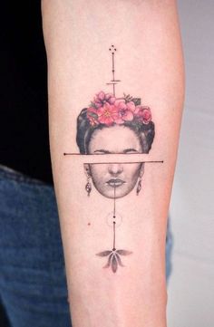 a woman's face with a cross and flower in her hair on the arm