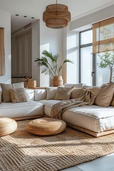 a living room filled with lots of furniture next to a large window covered in bamboo shades