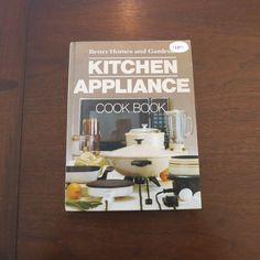 the kitchen appliance cook book is sitting on a table