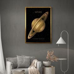 a living room with a couch, chair and painting on the wall that says saturn