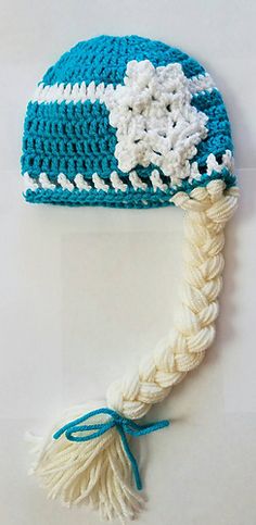 a crocheted blue and white hat with tassels