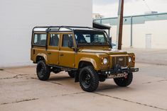 a yellow jeep parked in front of a building