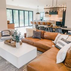 a living room filled with furniture and lots of windows