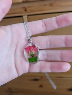 The charm for the necklace is made from epoxy resin with a real pressed flower inside. The flower is a rose bud from Idaho. It has a metal base around the charm, which matches the chain. It is very lightweight and perfect for any occasion, whether formal or casual. Rose Flower Jewelry With Pressed Flowers, Rose Flower Shaped Jewelry With Pressed Flowers, Green Goddess, Kind Person, Rose Bud, Wing Earrings, Pressed Flower, A Rose, Real Flowers