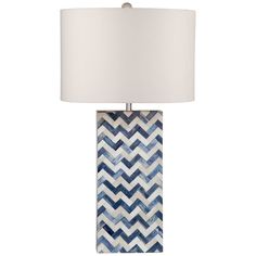 the blue and white chevron lamp is next to a white lampshade with a light on it