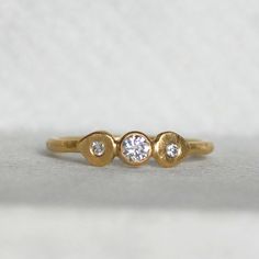 I hand forged the band out of rich 18k yellow gold, leaving a subtle hammered texture. I then added a sparkly 3.5mm diamond. Next to the glittering diamond sits little handmade lotus petals set with diamonds. If you like high quality materials, but prefer an understated classic look with a twist, then this elegant ring is the ideal choice for you. Makes the sweetest little unique wedding or engagement ring, or maybe you just want to treat yourself and wear it as a luxurious stacking ring! Detail Hand Forged Diamond Wedding Ring, Hand Forged Diamond Ring As A Gift, Hand Forged Diamond Ring For Gift, Heirloom Style Recycled Gold Diamond Ring For Wedding, Hand Forged Diamond Ring For Anniversary, Hand Forged Diamond Anniversary Ring, Hand-forged Diamond Anniversary Ring, Gold Hand Forged Diamond Ring For Anniversary, Anniversary Gold Hand Forged Diamond Ring