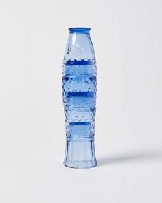 a blue water bottle sitting on top of a white table