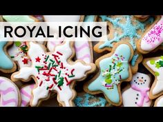 royal icing cookies with frosting and sprinkles are displayed on a table