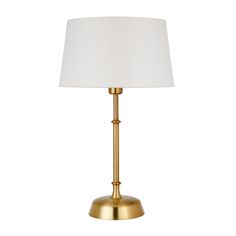 a gold table lamp with a white shade