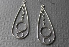 Gorgeous large sterling silver drop earrings and have different sized bubbles and squiggles. These would be a fantastic gift idea. They are made with sterling silver and love. They are tumbled to give them a lovely shine and harden them also. They have handmade French hook earring wire and it come in a gift box.Size- 2.5 inches long (3 inches including ear wire) / 7/8 inches wide **All pictures are close up shots to show details of the piece(s) PLEASE read description carefully for measurements. *Processing time on orders is within 2-5 business days (m-f) before your order will be shipped. Thank you so much for looking. ~Trina Freeform Sterling Silver Earrings As Gift, Modern Wire Wrapped Sterling Silver Earrings, Sterling Silver Freeform Earrings As Gift, Elegant Silver Freeform Earrings, Handmade Modern Sterling Silver Earrings, Modern Handmade Sterling Silver Earrings, Modern Silver Freeform Jewelry, Modern Freeform Silver Jewelry, Culottes Skirt