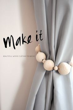 the word make it written in black ink on a curtain with seashells attached