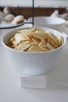 a white bowl filled with chips on top of a table