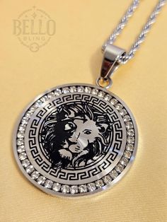 Stainless Steel Necklace: Show your strength and majesty with this Silver Lion Pendant Necklace. Featuring an intricate lion design surrounded by a classic Greek key pattern and sparkling crystal accents, this necklace symbolizes power and elegance. Made from high-quality stainless steel, it's a durable and stylish addition to any wardrobe. Pendant Material: High-quality stainless steel Chain Material: Stainless steel chain Style: Bold fashion, lion king design, Greek key pattern Features: Intri Lion King Design, King Necklace, Roi Lion, Lion Pendant, King Design, Greek Key Pattern, Lion Design, Power Symbol, Greek Key