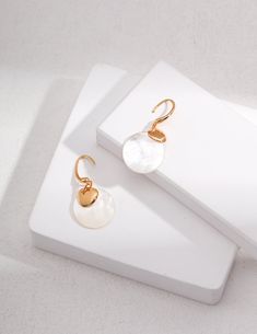 Introducing our exquisite "Mother-of-Pearl Earrings: Ethereal Elegance" - crafted with premium S925 silver and enhanced by the ethereal beauty of mother-of-pearl. With its timeless elegance and mesmerizing play of colors, these earrings add a touch of sophistication to any occasion. Elevate your ear ensemble now! Metal: 18K Recycled Gold Plated Vermeil on Recycled Sterling Silver Gemstone: Mother of pearl Pearl Dimensions: 20mm Dimensions: High 40mm, Width 20mm Freshwater Pearl Jewelry, Mother Of Pearl Earrings, Mother Pearl, Shell Earrings, Ethnic Style, Silver Pieces, Recycled Sterling Silver, Pearl Size, Crystal Pearls