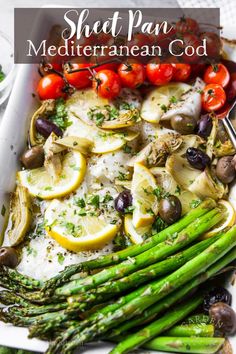 sheet pan mediterranean food with asparagus and tomatoes