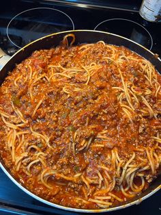 a pan filled with spaghetti on top of an oven