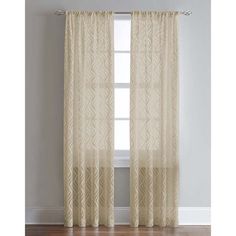 the curtains in this room are made from sheer fabric and have an intricate pattern on them