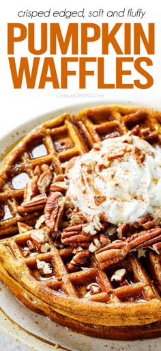 pumpkin waffles topped with whipped cream and pecans on a white platter