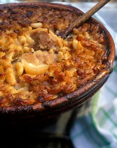 a close up of a casserole dish with meat and beans in it on a table