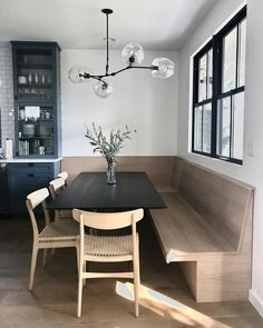 a dining room table with chairs and a bench