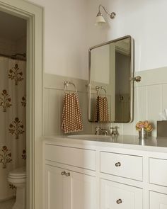 a bathroom with two sinks and a mirror on the wall next to a shower curtain