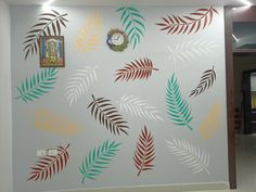 the wall is decorated with different colored leaves