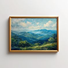 a painting hanging on the wall in front of a white wall with a gold frame