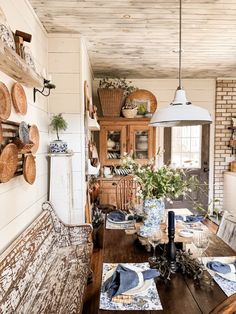 a dining room table is set with place mats and placemats on the wall