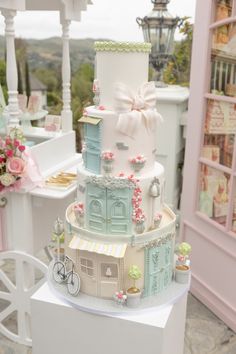 a three tiered cake with pink and blue decorations