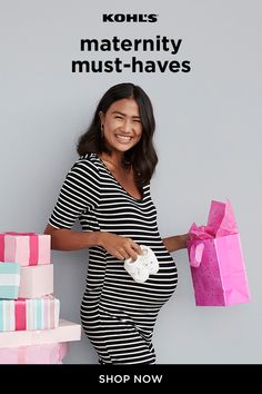 a pregnant woman is holding shopping bags and smiling for the camera while standing in front of presents