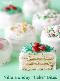 there are many different types of cakes on the table together, including one with white frosting and green sprinkles