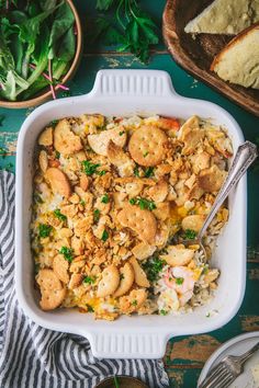 a casserole dish filled with chicken and rice, garnished with parsley