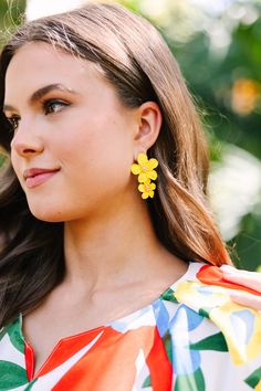 These vibrant flower earrings are so cute! We love the pop of color for spring! These beauties are going to look so good with light little sundresses this season! Chic Summer Jewelry With Flower Charm, Spring Flower Earrings For Parties, Flower-shaped Earrings For Summer Parties, Beach Jewelry Spring Drop Earrings, Flower Shaped Summer Party Earrings, Yellow Flower Earrings For Party, Chic Flower-shaped Earrings For Spring, Chic Spring Jewelry With Flower Charm, Chic Spring Earrings For Vacation