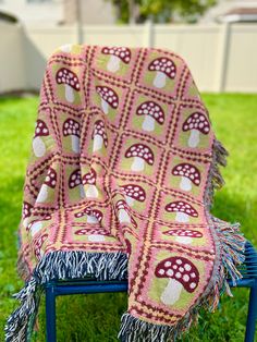 a blanket sitting on top of a chair in the grass