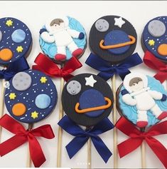 cupcakes decorated with space themed icing on sticks