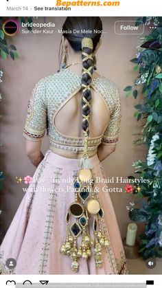 the back of a woman's pink lehenga